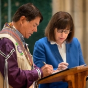 Jason Koski/Cornell University Ray Halbritter, left, representing the Oneida Indian Nation, and President Martha E. Pollack, sign documents that repatriate ancestral remains from the university to the Oneida Indian Nation.