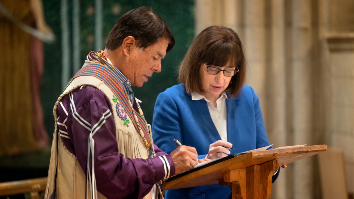 Jason Koski/Cornell UniversityRay Halbritter, left, representing the Oneida Indian Nation, and President Martha E. Pollack, sign documents that repatriate ancestral remains from the university to the Oneida Indian Nation.