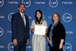Karris Leonard ‘23, of Ilion, NY, receives the SUNY Chancellor’s Award for Student Excellence from Chancellor John B. King, Jr. Leonard is joined by Herkimer College President Cathleen C. McColgin, Ph.D.