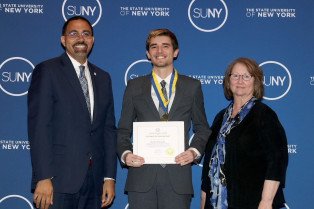 Kyle Poulos ‘23, of Niagara Falls, NY, receives the SUNY Chancellor’s Award for Student Excellence from Chancellor John B. King, Jr. Poulos is joined by Herkimer College President Cathleen C. McColgin, Ph.D.