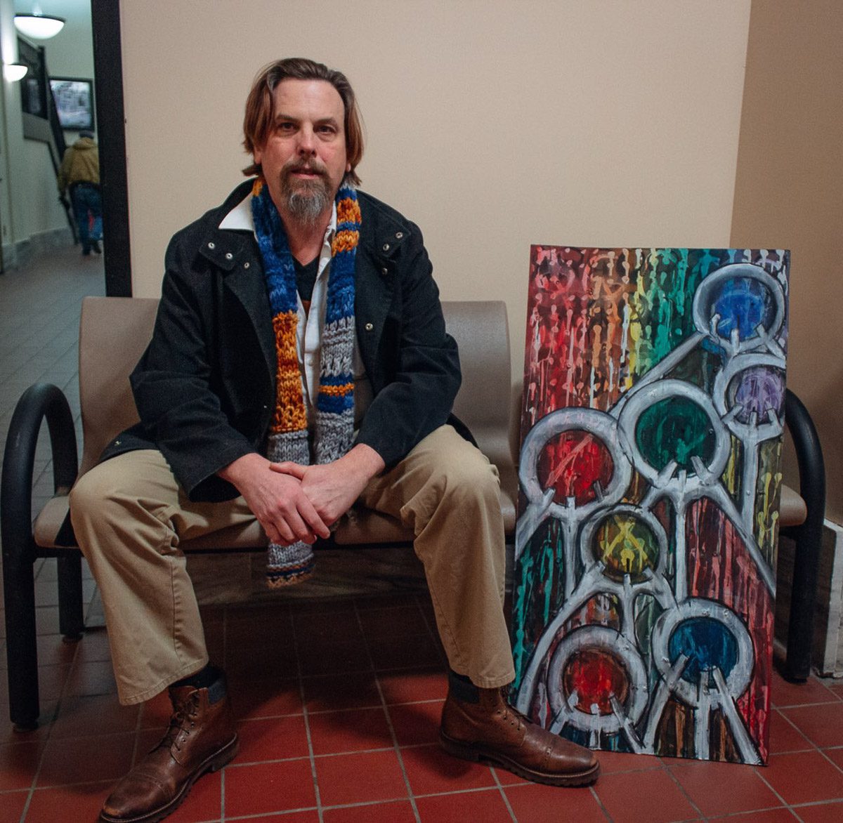 Photo of Walter Ricci-Wadas with his painting "We Are One" at Union Station in Utica, NY. Photo by Alexander Ackerman.