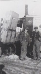 Employees Jimmy Fitzgerald (on right) and Al Munger loading Snyder's bicycles onto railroad carts outside Little Falls train depot building. Photo courtesy of the Little Falls Historical Society.