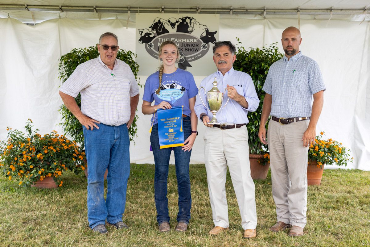 The F. Ambrose Clark Livestock Cup Winner: Mikaylee Woodin of Walton, NY showing her Market Hog “Grunkle.” Also pictured: Clyde Cranwell and Ben Williamson, Livestock Judges, and Paul D’Ambrosio, President & CEO of The Farmers’ Museum.