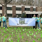 Montgomery County Clerk Brittany Kolbe and DMV staff stand behind 377 flags displayed in front of the Fonda DMV, each representing a New Yorker who lost their life while waiting for an organ transplant. The display is part of the County Clerk’s efforts to raise awareness during Donate Life Month and encourage residents to register as organ donors.
