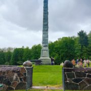 Dr. Oscar Stivala playing "Taps" in front of Herkimer Home obelisk.