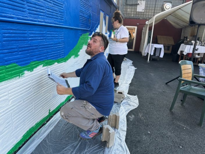 Justin Como as Lead Artist at the Stone Soup American Bistro and Beer Garden Mural Event.