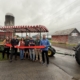 The Coyne family and County officials gather for a ribbon cutting celebrating the new accessible hay wagon at Bellinger’s Orchard.